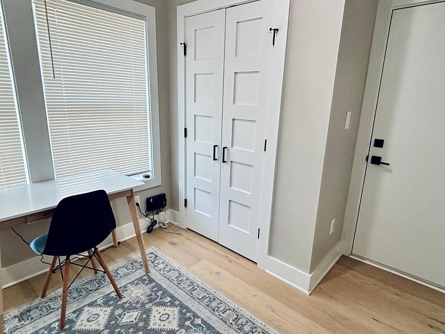 Second bedroom/office with desk, bookcase, twin bed, and closet