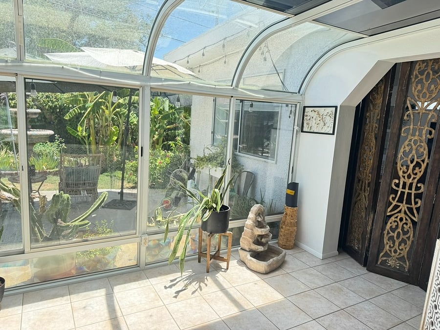 View of the backyard from inside the glass room