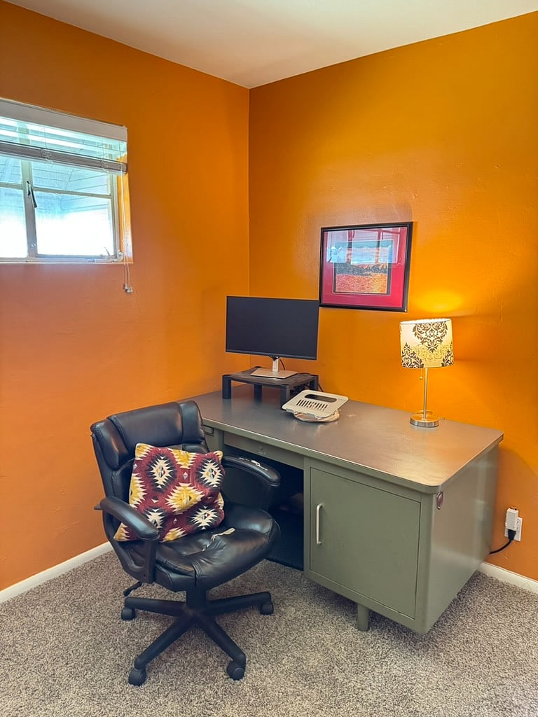 Office with a laptop stand, monitor to plug into at the desk
