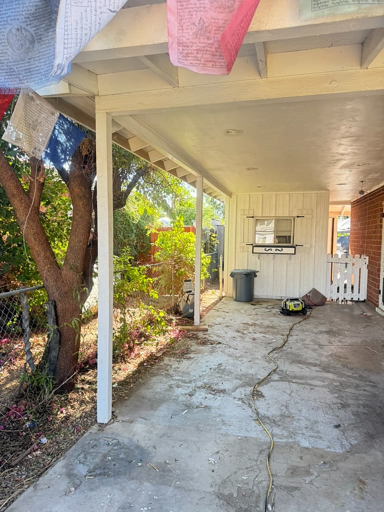 Large covered carport to keep your car out of the sunshine and to have easy access to the side or front doors.