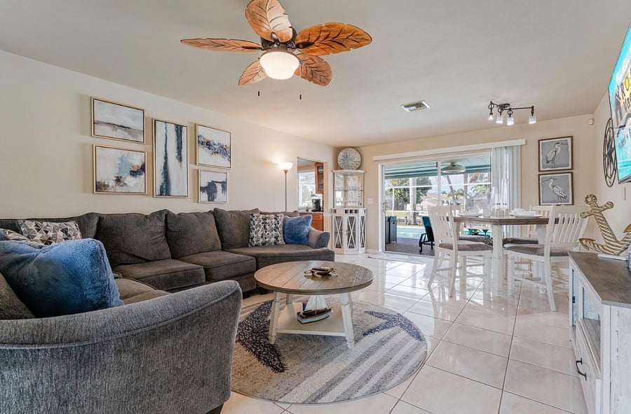 Living space takes you out the the lanai with outside living space and heated pool.