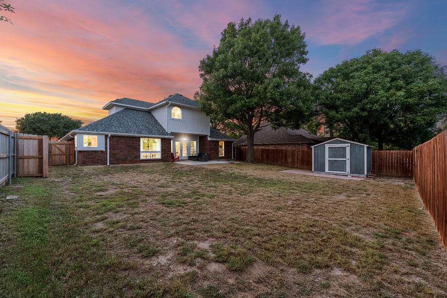 Private fenced back yard with large storage shed.