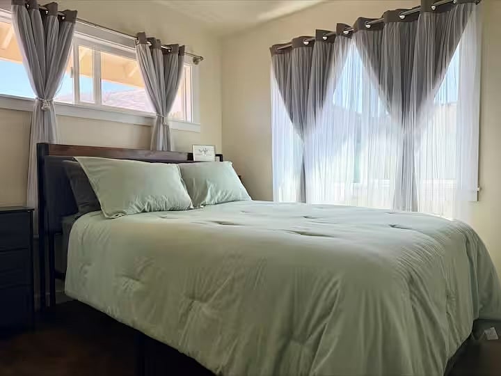 Queen size bed in bedroom.