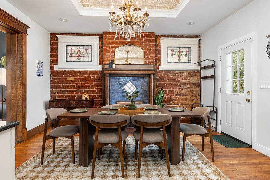 Dining room, with stained glass windows, decorative fireplace and exit to the back deck.