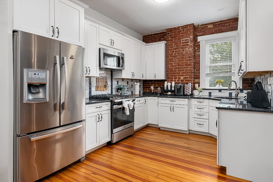 Fully equipped kitchen with gas stove, dishwasher, coffee maker, built in microwave, dishes, and full refridgerator.