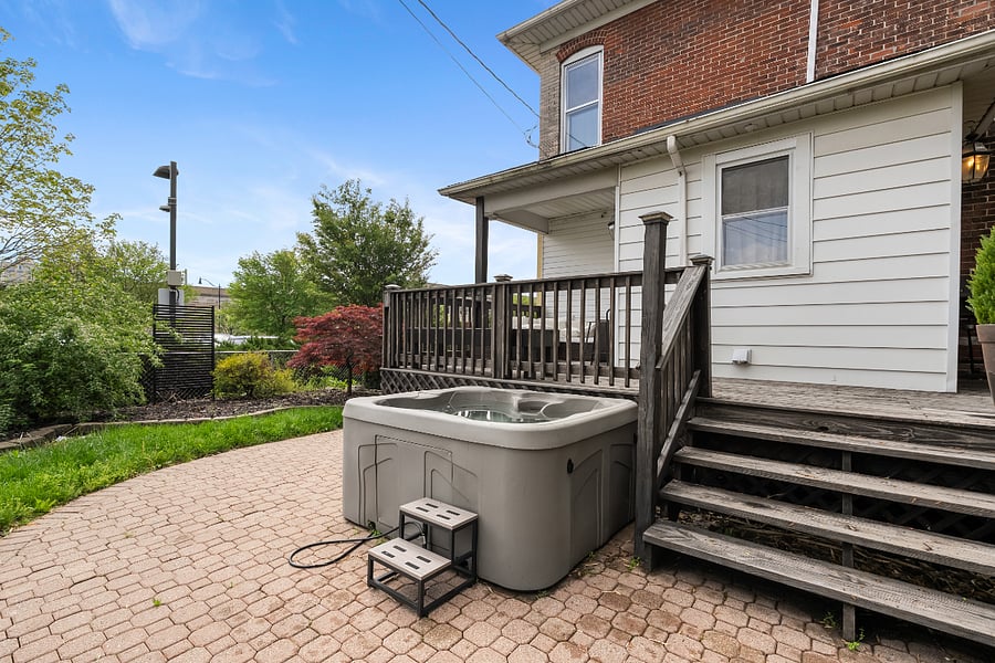 Backyard with deck and hot tub.