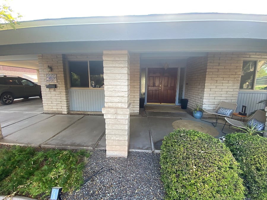 Carport next to mail and main entrance for the house (this is not your entrance).