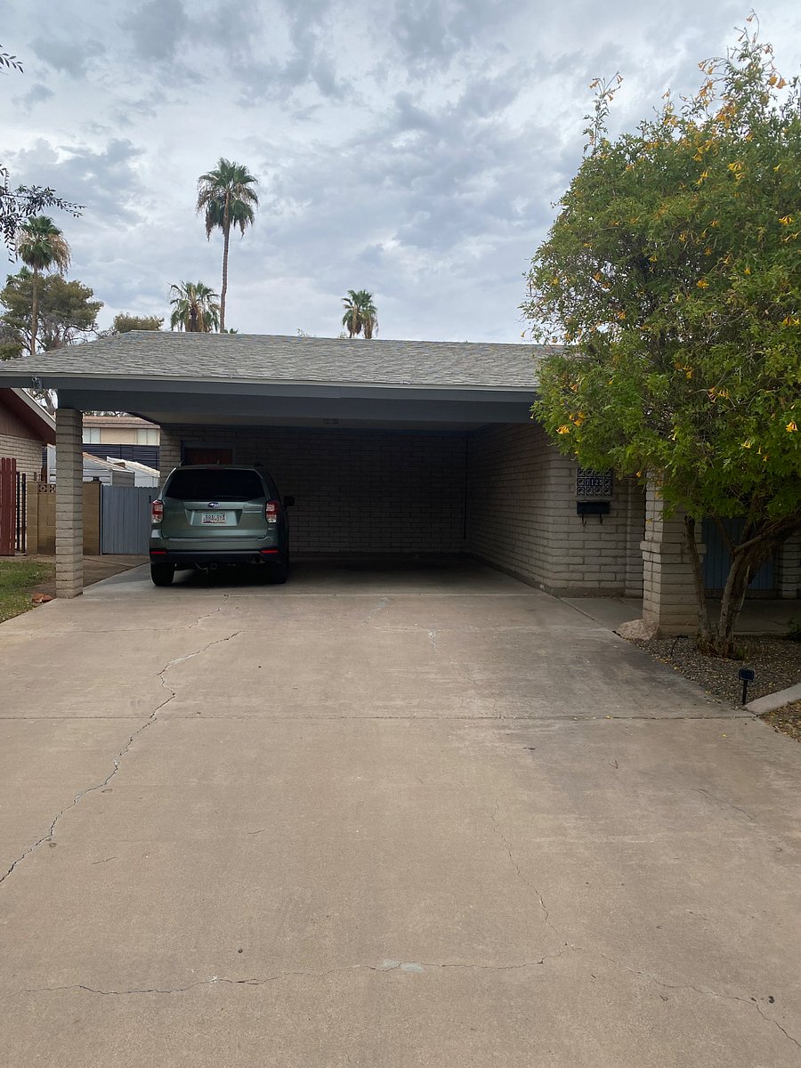 Covered private parking next to gate leading to backyard and studio entrance.