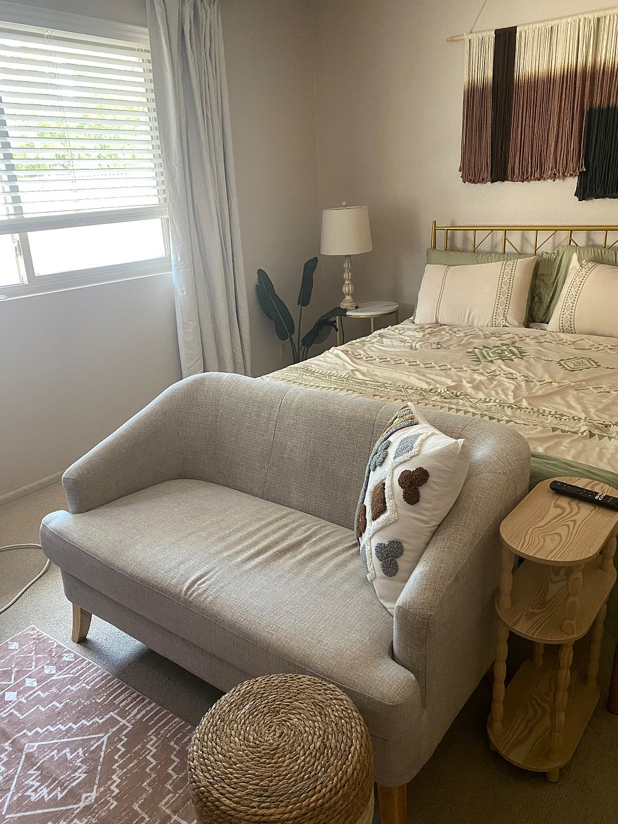 Relax on the petite couch or bed while watching the smart TV, window has views of landscape and palm trees swaying in the wind. 