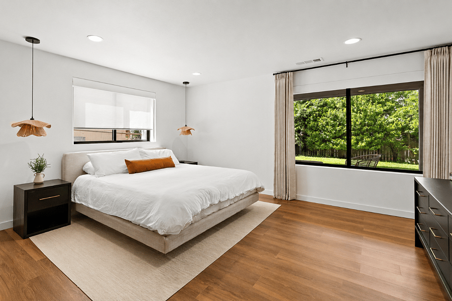Spacious king bedroom with dual light-filtering or blackout shades for a restful night's sleep.