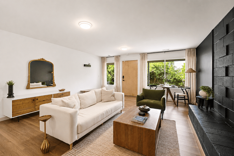 Large windows with remote-controlled light-filtering privacy shades, plus a convenient entry area with coat hooks, umbrellas, reusable shopping bags, and a bench for taking shoes on and off.
