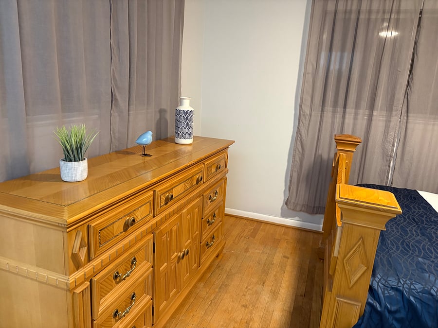 Second bedroom includes comfortable queen bed, fresh linens, beautiful views of treetops, and peeks of city lights. 