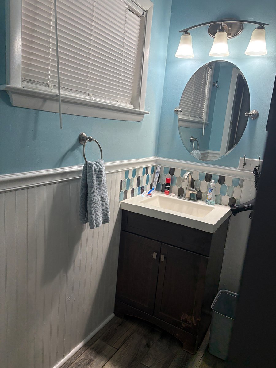 The Primary en suite features storage, starter toiletries, and freshly laundered towels. 