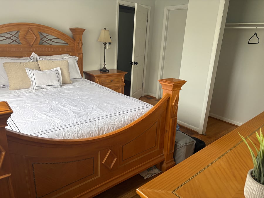 Second bedroom features a queen bed, dresser for storage, and full-size closet. 