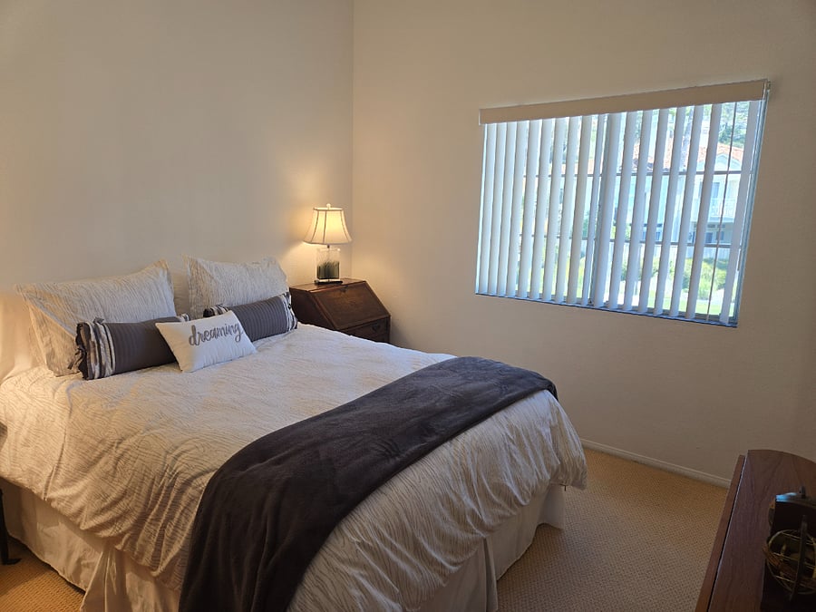Queen Bedded room overlooking green space.