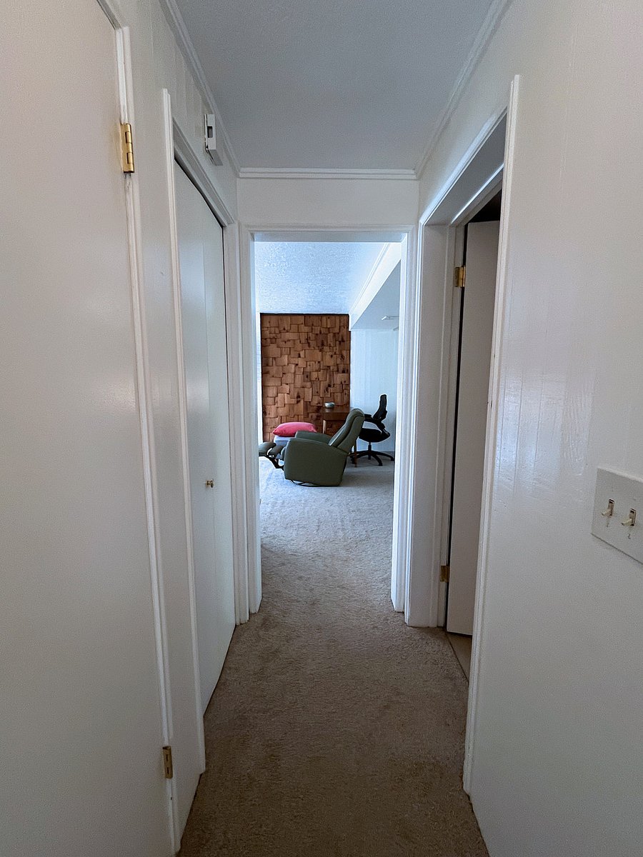 Hallway from bedrooms/bathroom leading to living area and the kitchen on the right hand side.