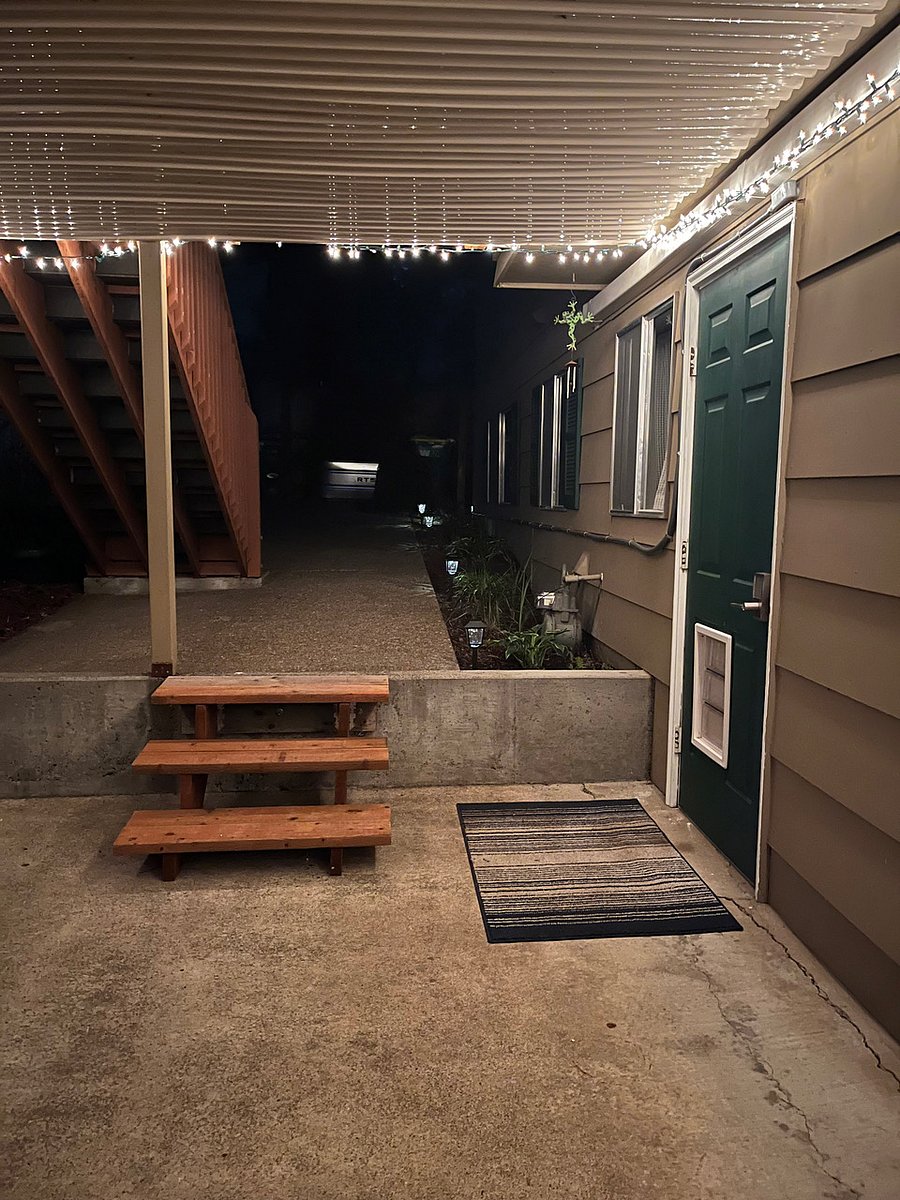 Nighttime view of stairs leading to entrance. Motion sensor lights are always on.