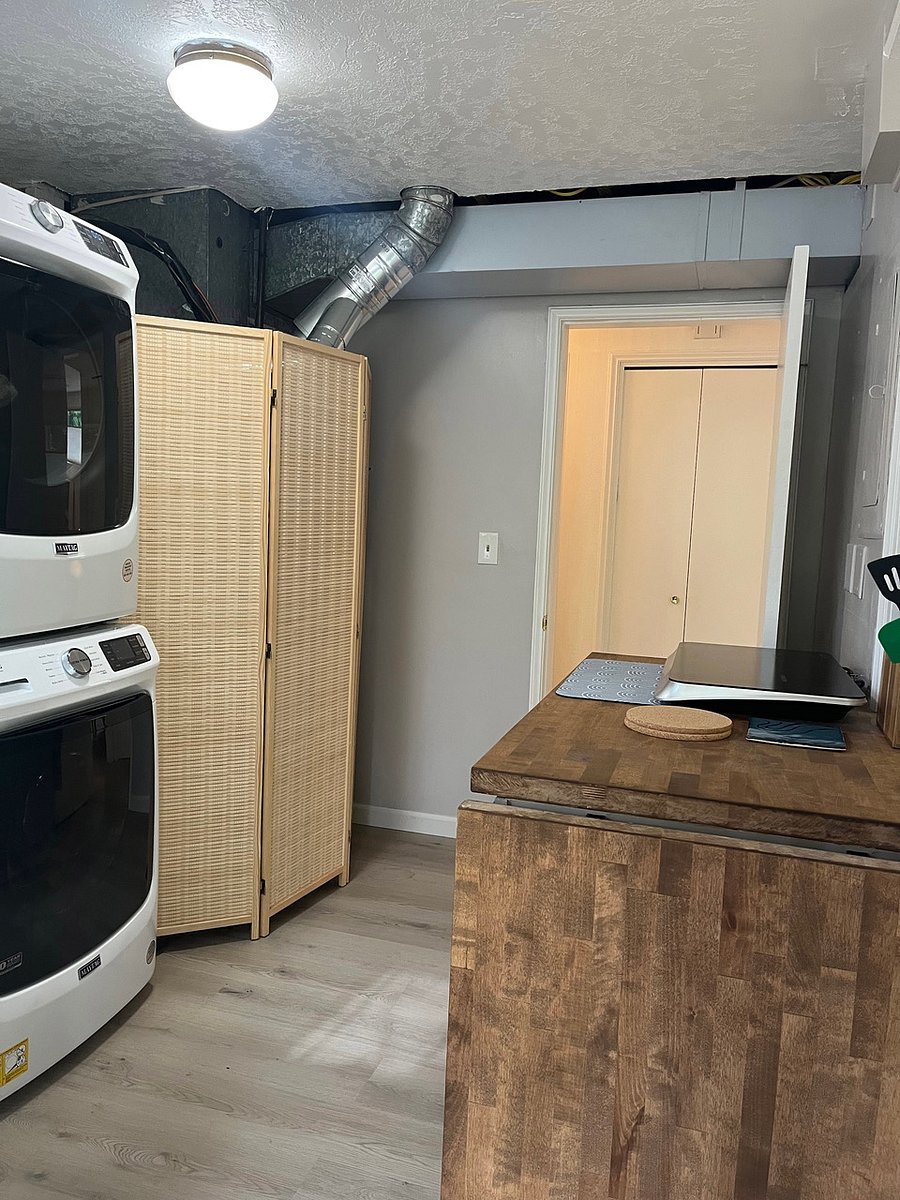 View as you enter front door. Bamboo furnace divider and washer/dryer on left.