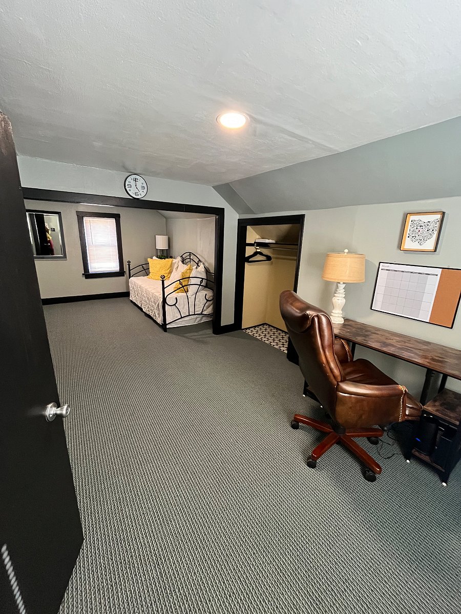 Second floor bedroom with two closets, one built in dresser and a twin daybed