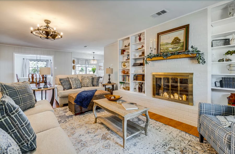 Cozy Living Room with candles in fireplace to give you all the feelings of home.