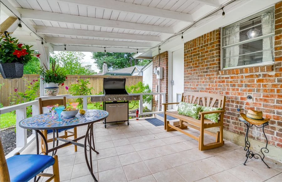 Back Patio with table, bench, rocker and grill.