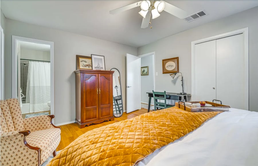 Primary Bedroom - TV is located in Entertainment Center. Ensuite Bathroom entry is pictured