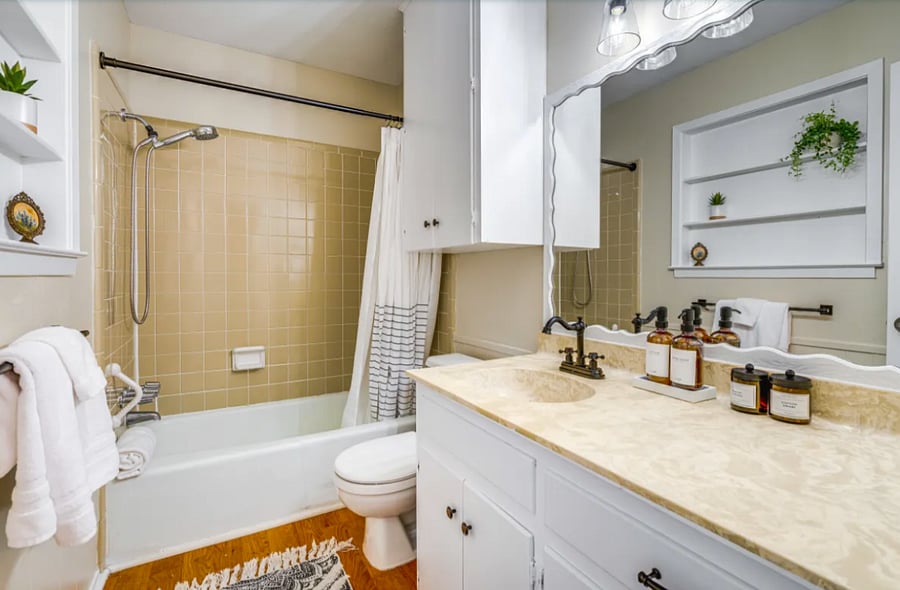 Ensuite bathroom accessible through primary bedroom features tub and shower.