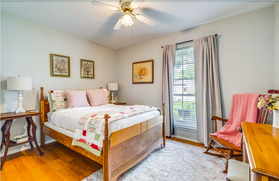 The "Pink Bedroom" with a full bed, rocker and dresser.