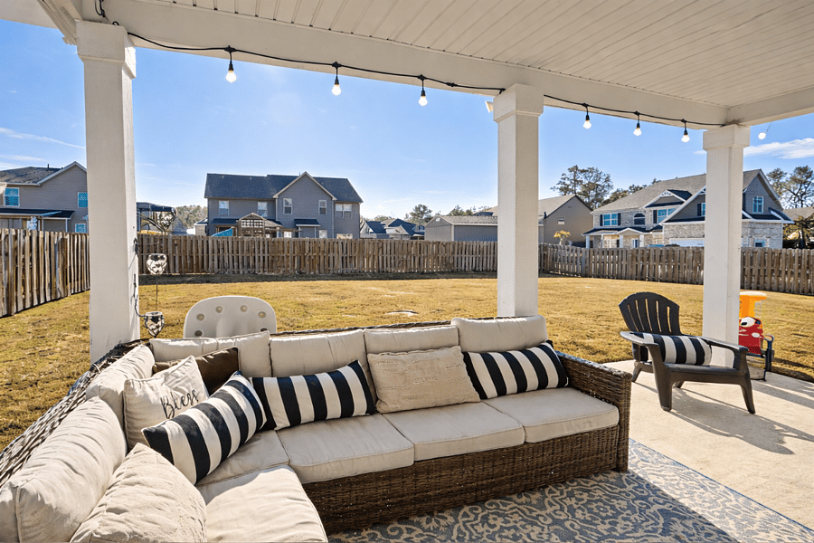 Large fenced in backyard with Smart TV, grill, sandbox, perfect for unwinding after a long day.