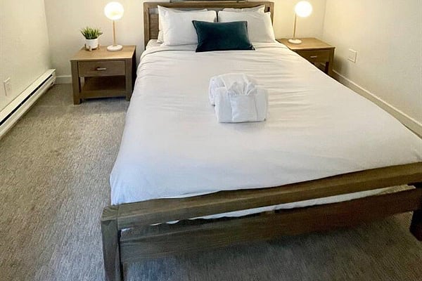 Comfortable main level queen bedroom with large window