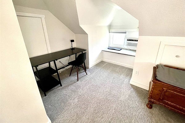 Relax in the spacious king bedroom with premium linens, AC, and desk!