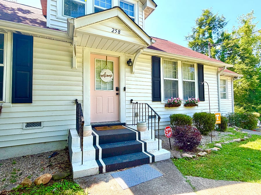 The front yard features wooden fencing and landscaping as well as parking for up to 3 vehicles.