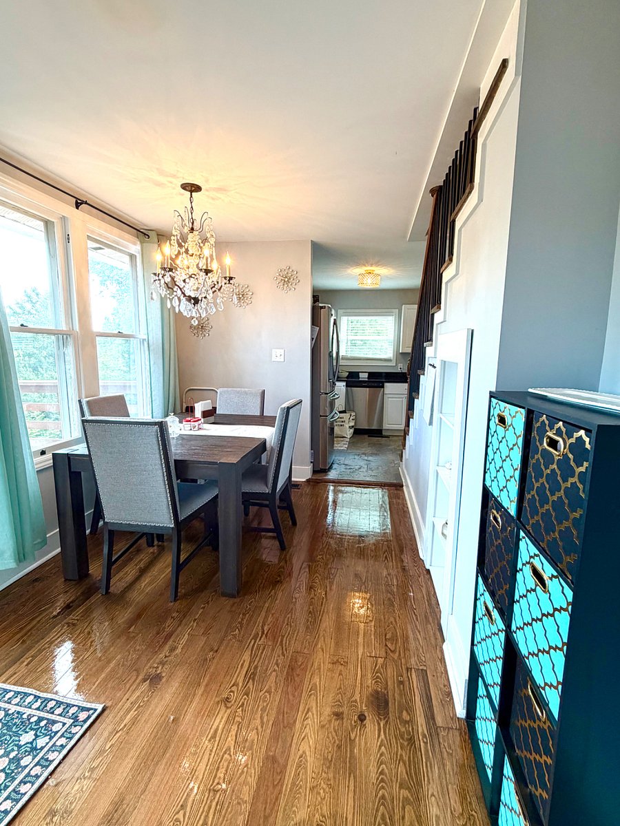 Dining room features a beautiful chandelier, dining for 4, and panorama view of the deck and half-acre back yard.