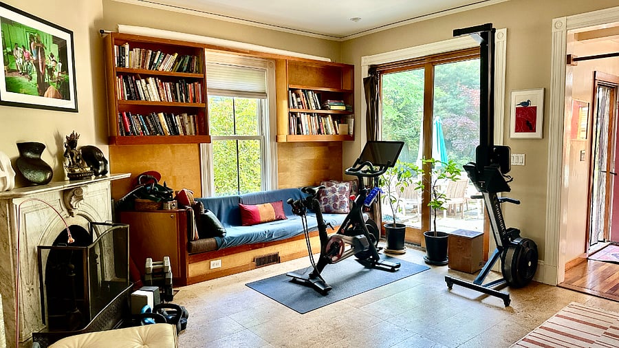 1st floor additional living room/area, with large desk, Peloton bike, rowing machine, weights, and room for art making, reading and relaxing