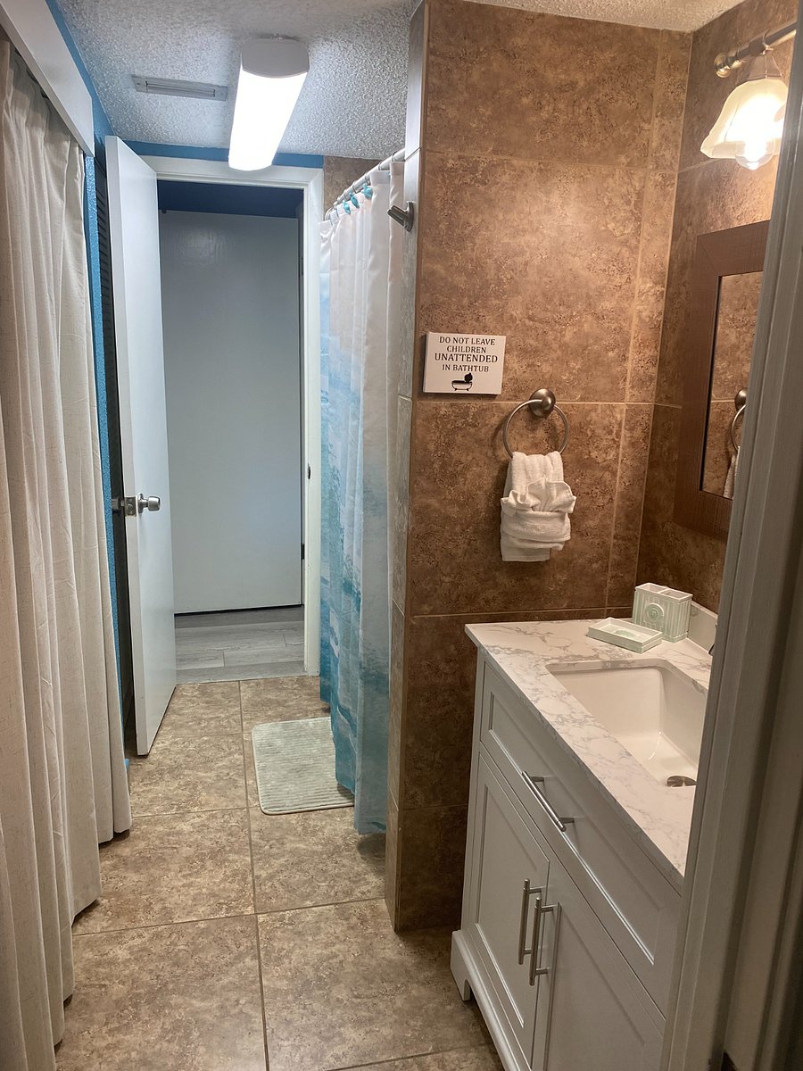 Bathroom closet holds ironing board, iron, shark mop/vac & cedar mop system