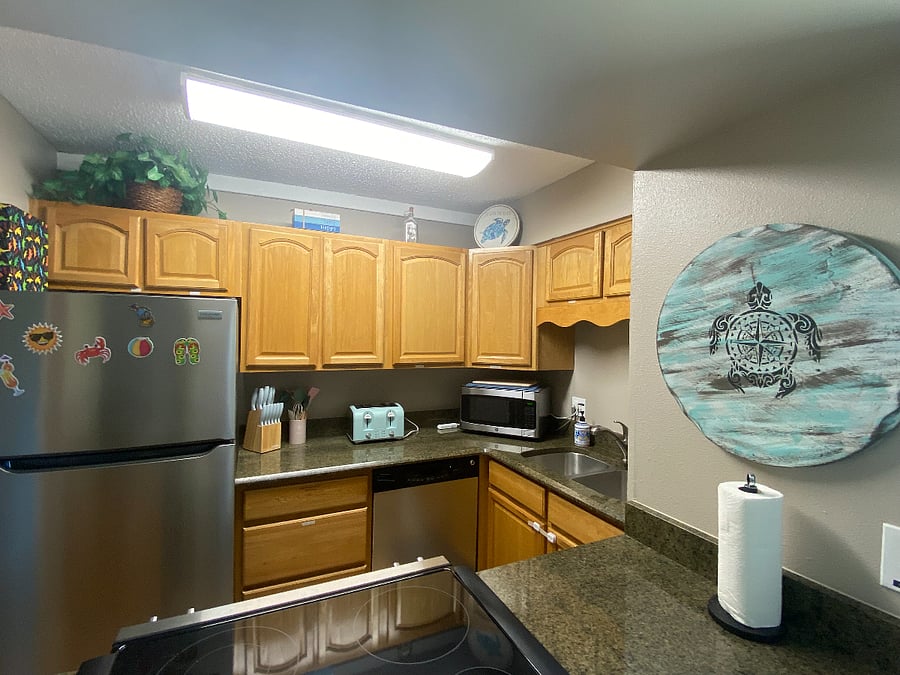 Many kitchen appliances: crockpot, stock pot, pots & pans, bakeware, storage ware, plates/bowls/cups/glasses, cooking utensils