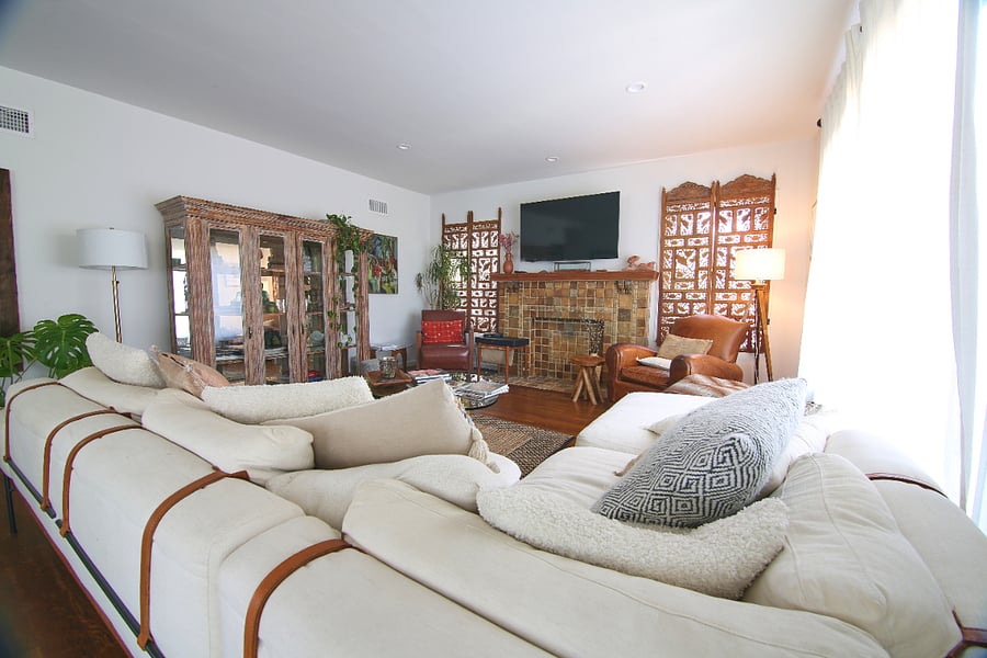 Comfortable seating, curated artwork, handcrafted furnishings, and a character-rich fireplace create
a living room that encourages conversation, movie nights, and quiet afternoons with a favorite book.
Every detail feels personal rather than staged.