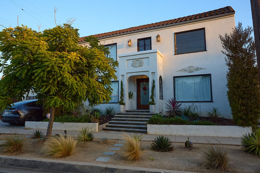 The striking Spanish-inspired facade welcomes guests with elegant symmetry, mature landscaping,
and classic architectural details. From the moment you arrive, the home feels private, refined, and
distinctly Los Angeles.
