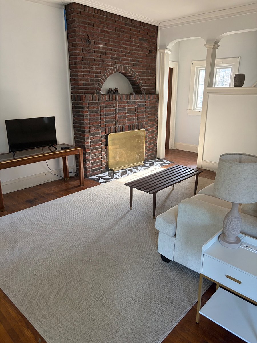 Large living room with decorative fireplace.