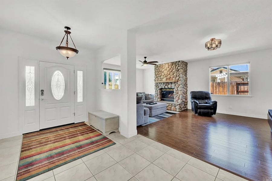 The front door leads into the living room, which features a fireplace.