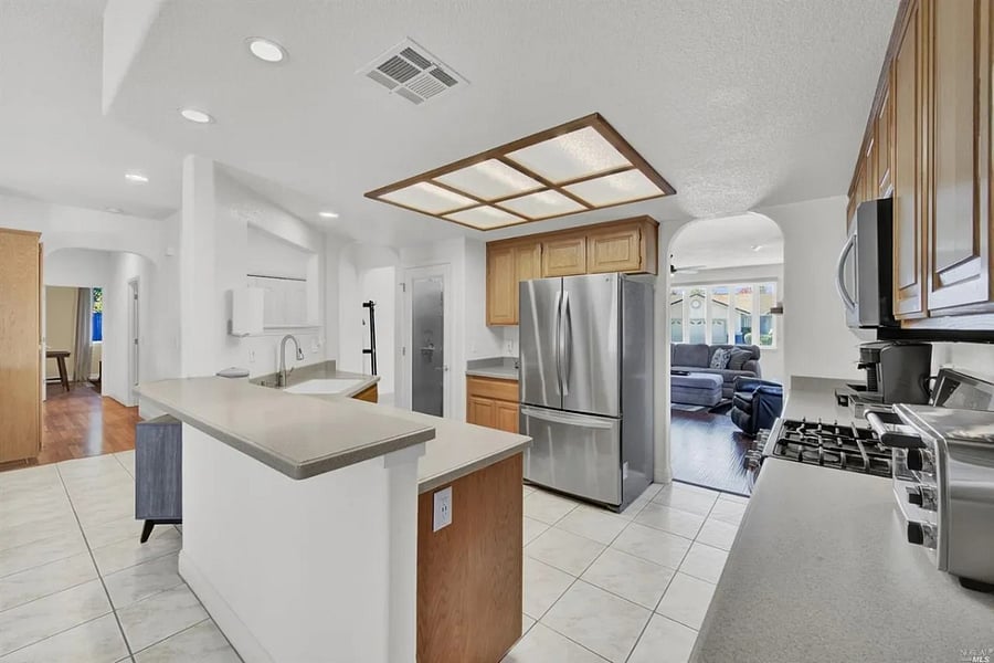 Kitchen and Hallway to the bedrooms. The first door on the left side is the 1st bathroom, and the right side is the laundry room and the door to the car garage