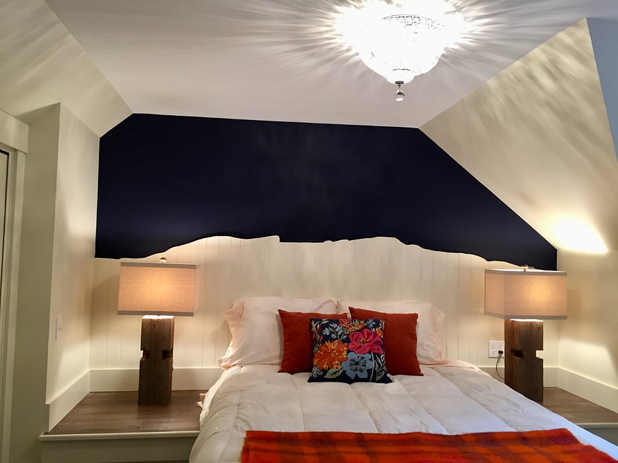 The bedroom features this queen size bed with a headboard made from 160 year old beadboard donated by a friend. The image is the profile of Vermont's highest peak, Mount Mansfield.