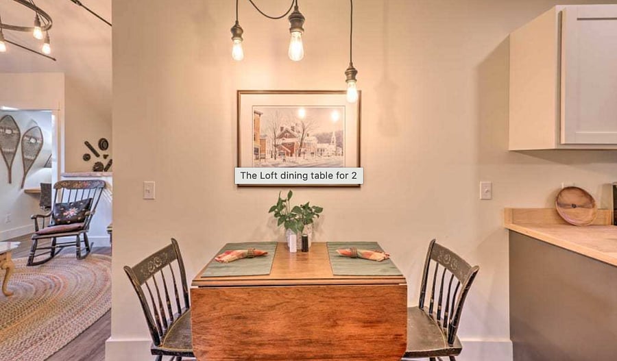 Antique drop-leaf table and stencilled thumb-back chairs create cozy meal times or additional work space.