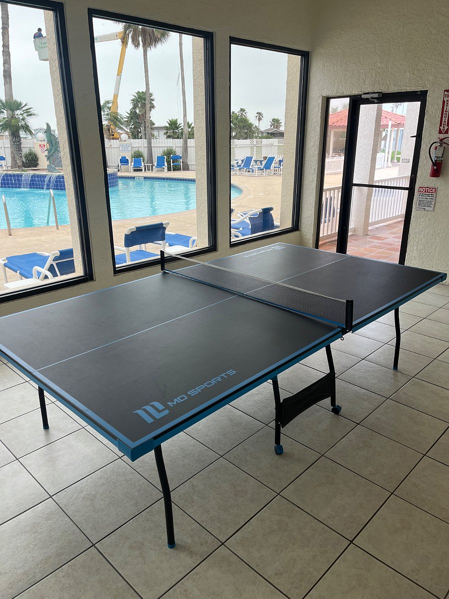 Ping pong table in activity center near pool.