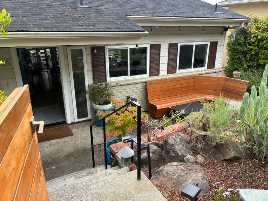 Front of house with bench and firepit.