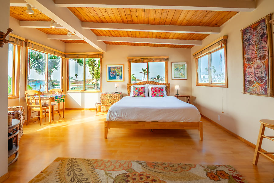 Grand Master Suite with amazing beach, island, mountain and city views. Sitting area with table and chairs, smart TV & ensuite