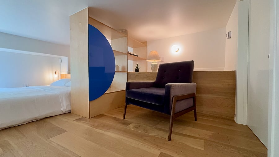 Lofted bedroom area features cozy reading nook.