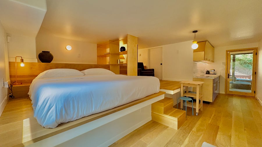 Lofted bedroom space features a premium king-sized Nectar memory foam mattress, king-sized hybrid supportive memory foam pillows and high-thread count Egyptian cotton linens.