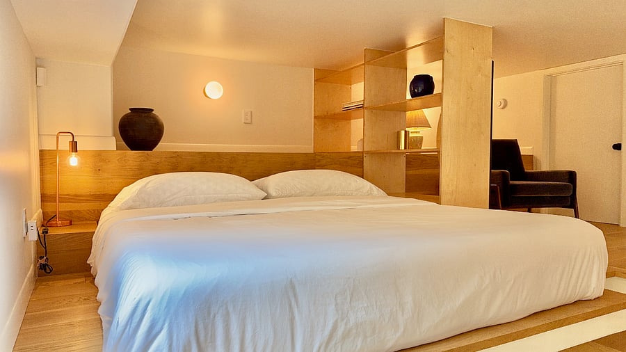 Lofted bedroom space features a premium king-sized Nectar memory foam mattress, king-sized hybrid supportive memory foam pillows and high-thread count Egyptian cotton linens.