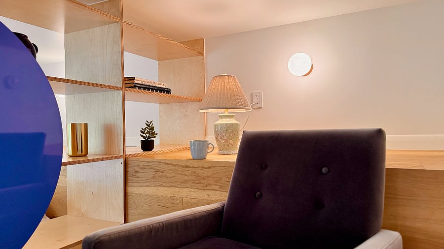 Lofted bedroom area features cozy reading nook.